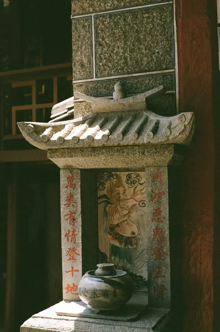 Intricate stone carvings and calligraphy on a Chinese temple wall in Thailand