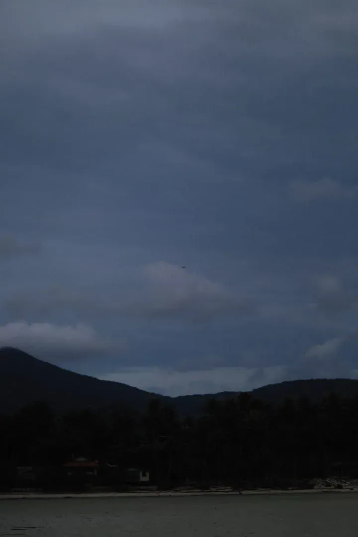 Dusk view of a river and mountains under cloudy skies inland on Koh Samui
