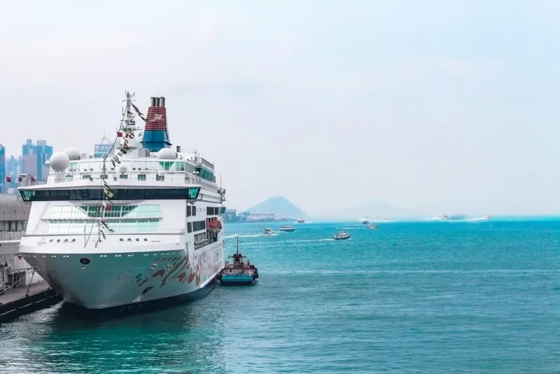 Cruise ship at a bustling harbor with clear water, similar to a Koh Samui shore excursion day