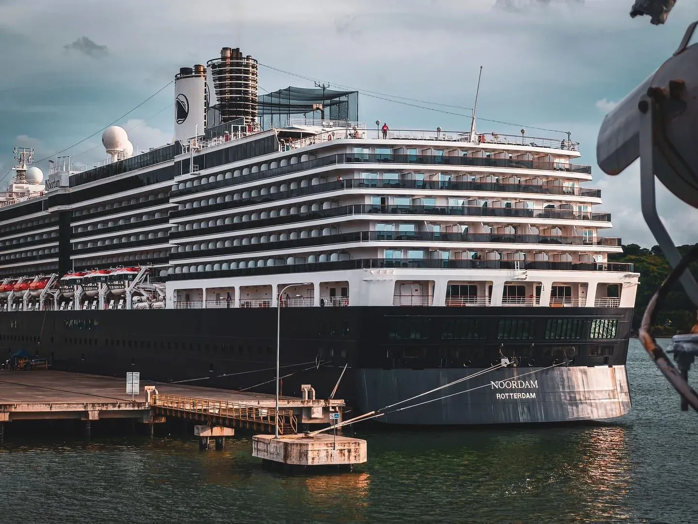 Large cruise ship anchored under a dramatic sky, representative of ships that stop offshore at Koh Samui