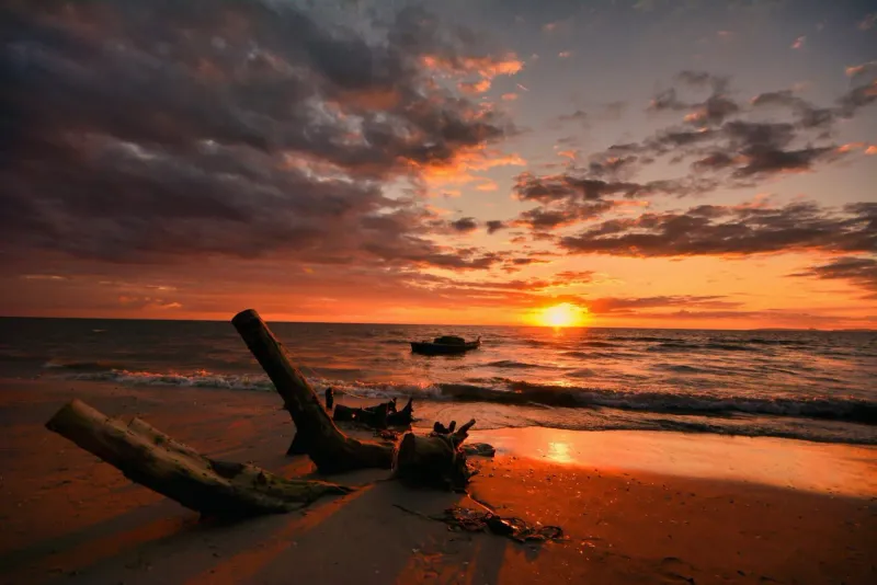 Vibrant orange sky over a calm beach typical of Koh Samui's west coast at Lipa Noi