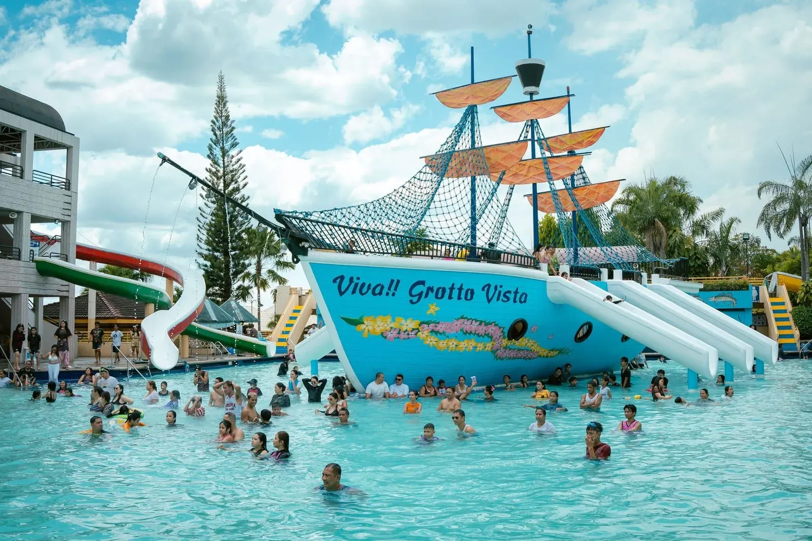 Families enjoying a resort swimming pool under bright skies at a Koh Samui family hotel