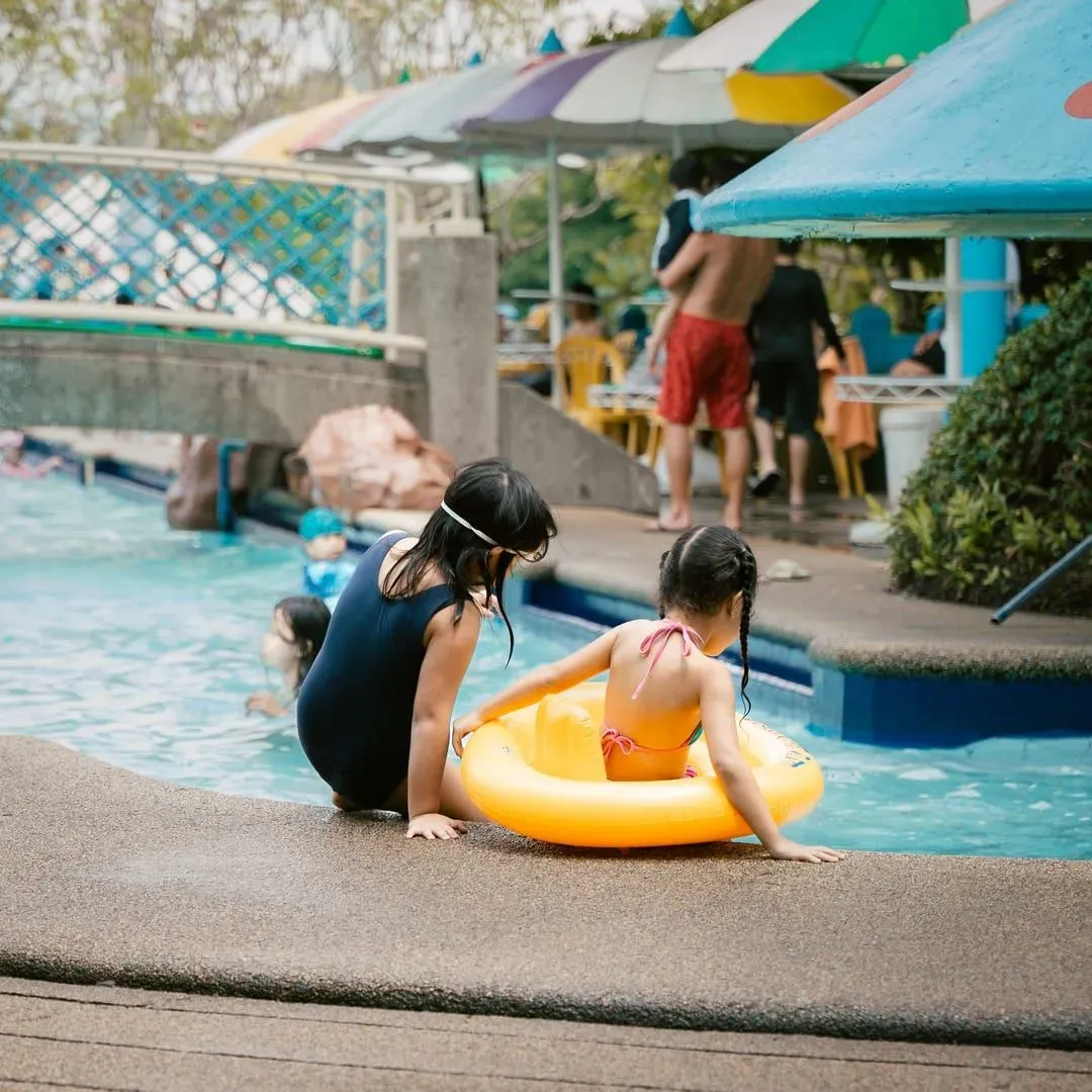 Two girls playing together in a swimming pool at a Koh Samui resort