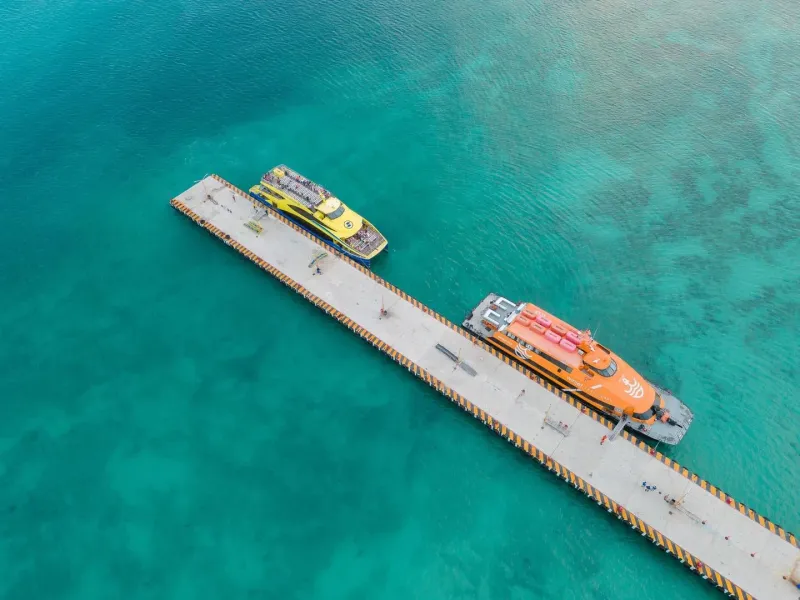 Aerial view of boats docked at a tropical pier similar to Koh Samui's ferry terminals