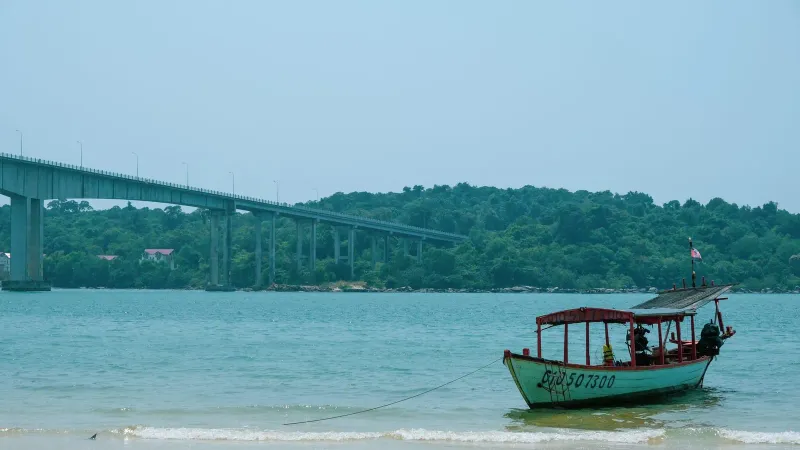 Boats moored near a seaside bridge, evoking Nathon's working harbor on Koh Samui