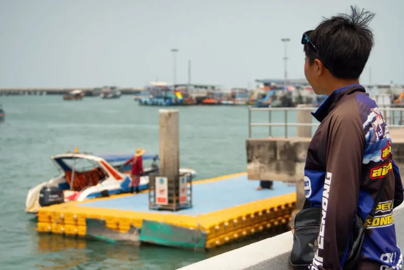 Traveler watching boats at a marina on the way to catch a ferry toward Koh Samui
