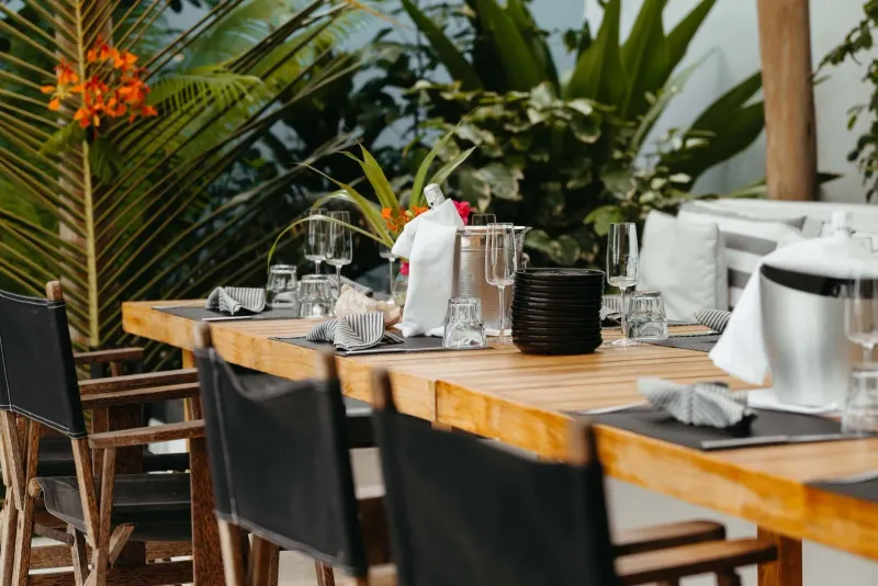 Spacious outdoor dining table set amid tropical greenery at a Koh Samui resort restaurant