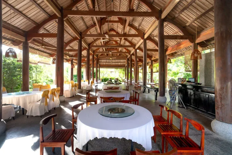 Covered pavilion-style dining area with wooden beams, a resort fine-dining setting on Koh Samui