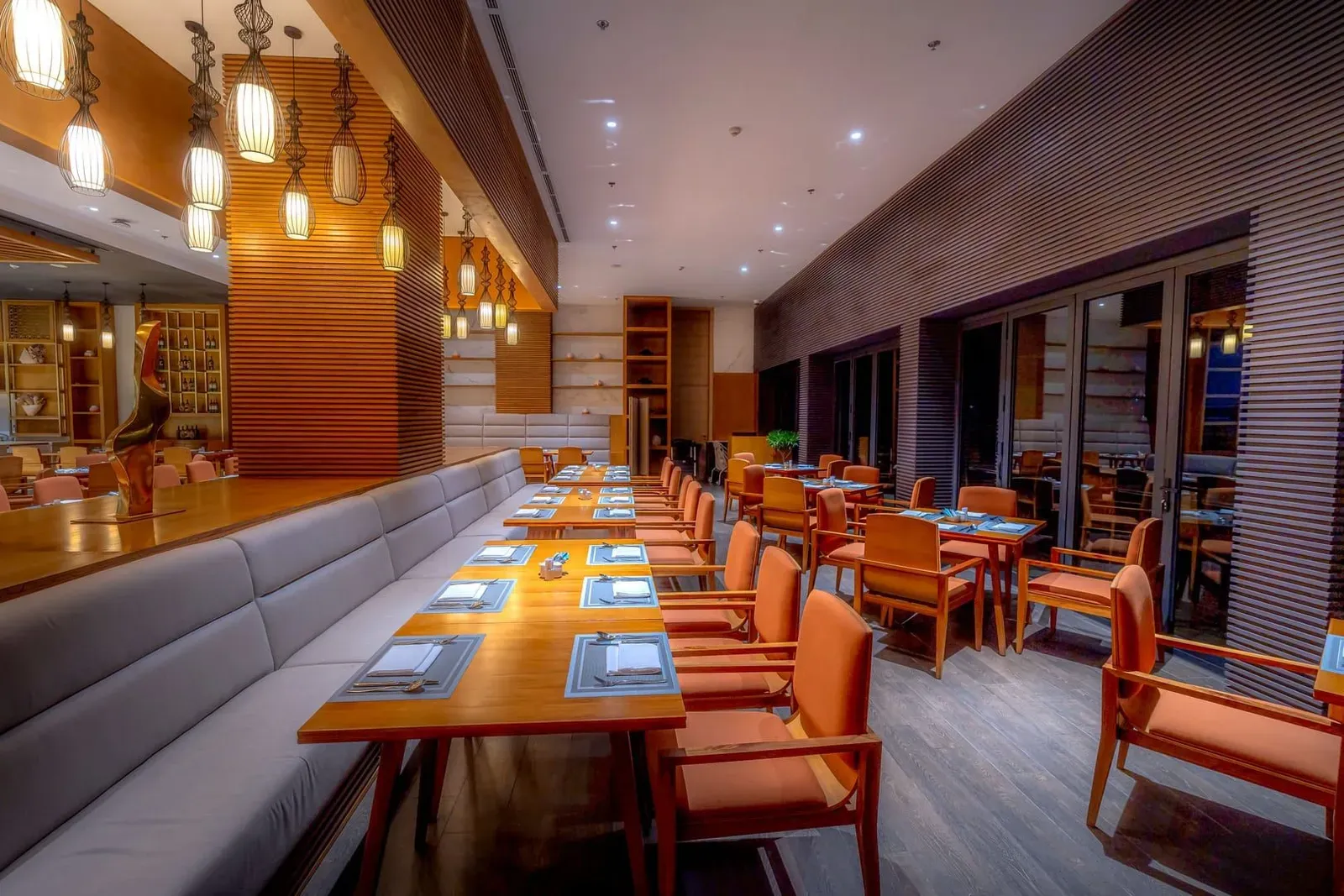 Elegant modern restaurant interior with warm lighting, the style of Koh Samui's resort fine-dining rooms