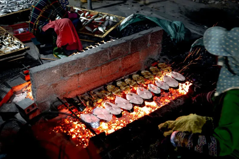 Grilled seafood and street food stalls at a Koh Samui market in the evening