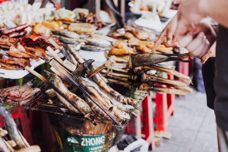 Close-up of fresh fish laid out on ice at a Koh Samui street market stall