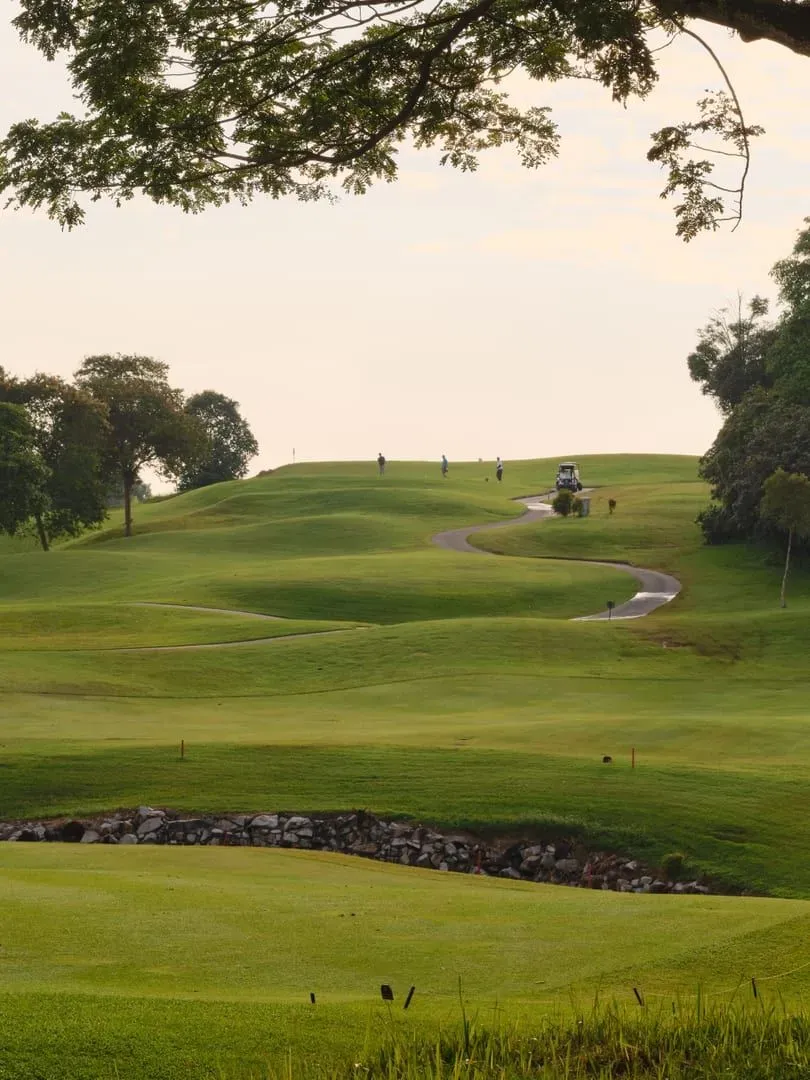Golf course at sunset with lush greenery, representative of late tee times on Koh Samui