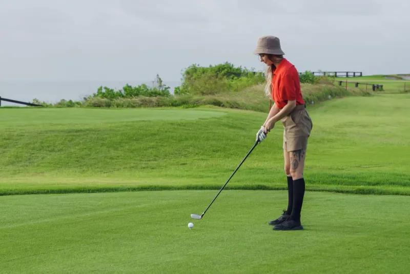 Golfer preparing to swing on a lush green course typical of golf courses koh samui
