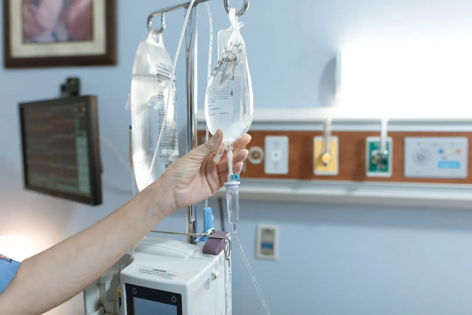Close-up of an IV drip line attached to a patient's hand during hospital treatment on Koh Samui