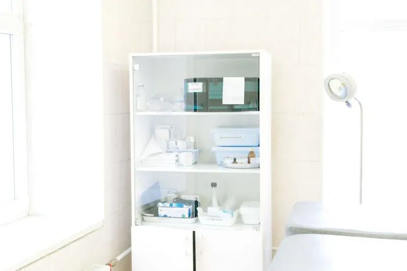 White medical cabinet stocked with instruments and supplies inside a Koh Samui hospital ward