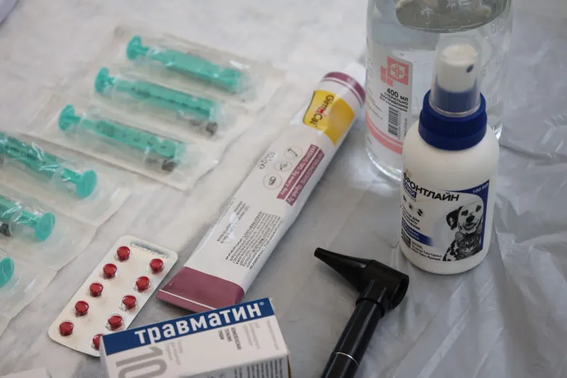 Medical supplies including syringes and pill packets laid out on a clinic table in Thailand