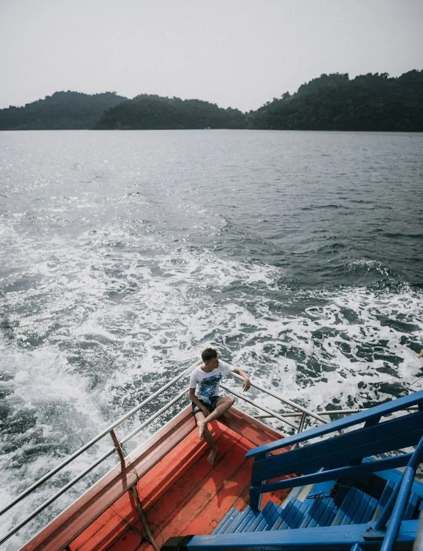 Traveler relaxing on a ferry pier overlooking the sea between Koh Samui and Koh Phangan