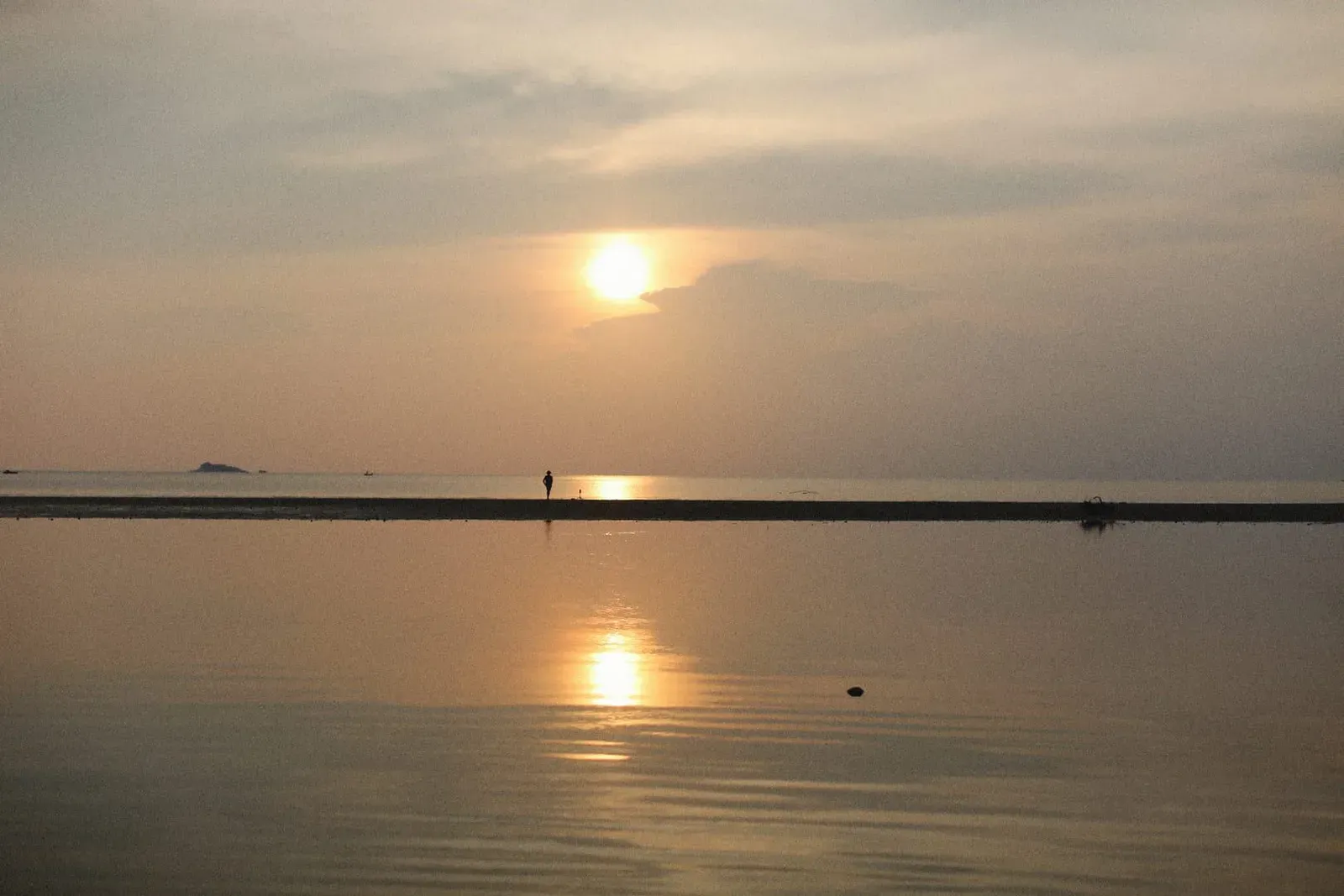Tranquil sunset reflections on calm water near Nikki Beach Club on Koh Samui's Lipa Noi coast