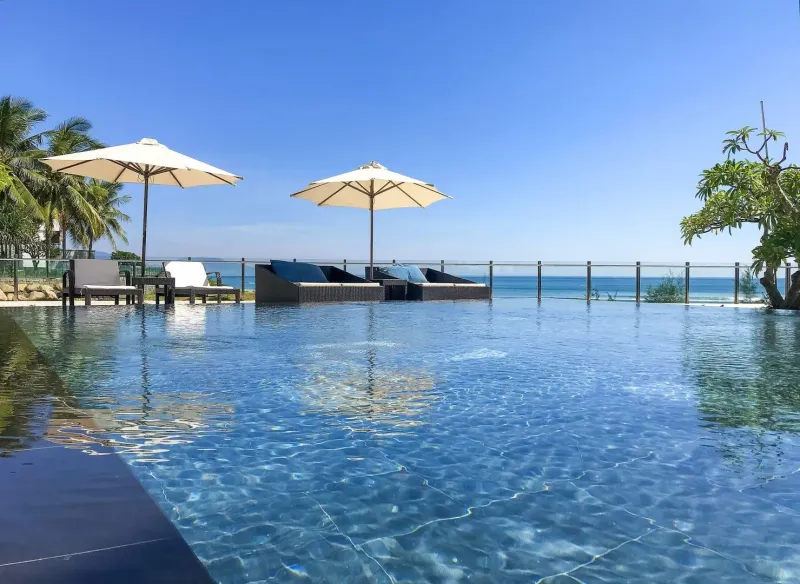 Poolside umbrellas and loungers at a Koh Samui hotel overlooking the Gulf of Thailand