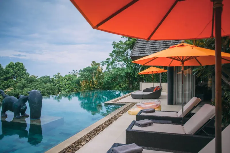 Orange poolside umbrellas at a boutique hotel on Koh Samui's northeast coast