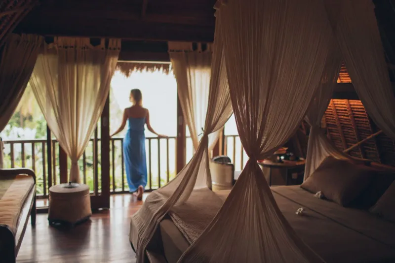 Peaceful bedroom with a balcony view inside a Koh Samui villa suite