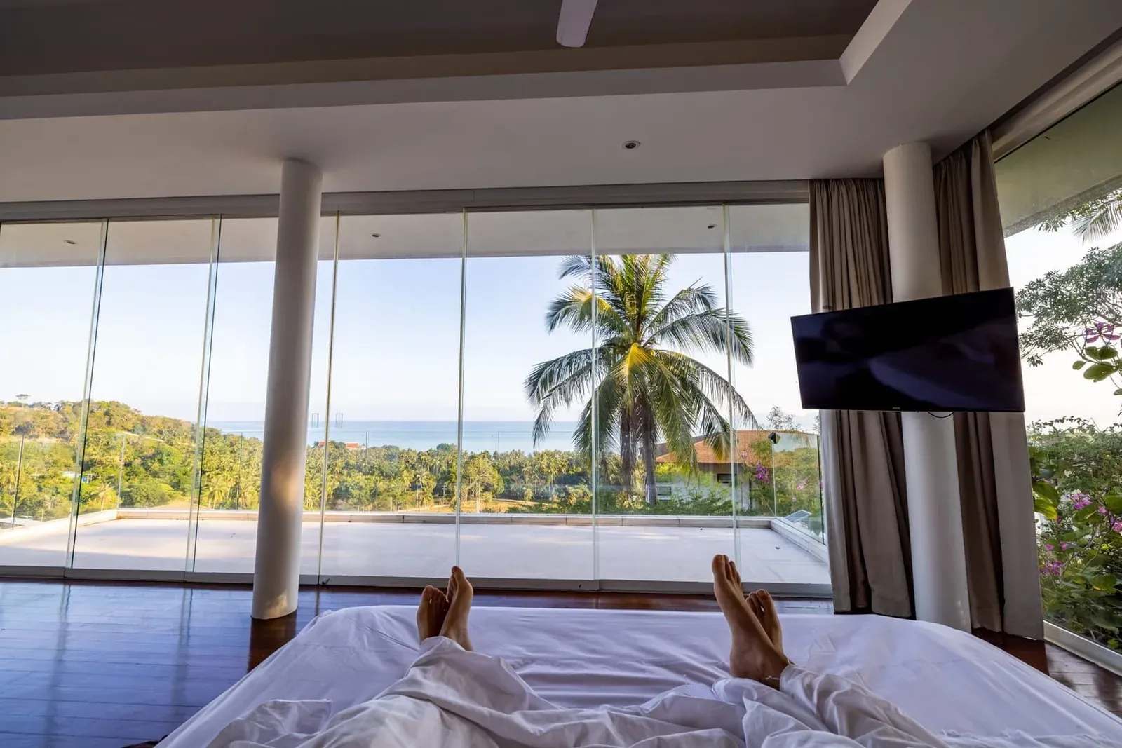 Luxury hotel room with ocean view and palm trees at a Koh Samui beachfront resort
