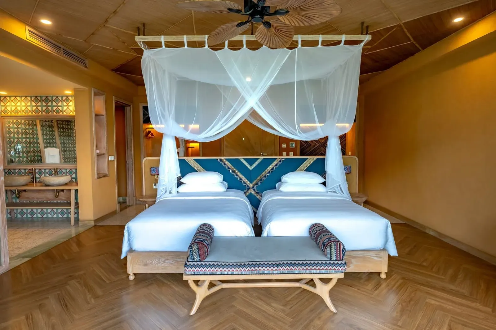 Spacious canopy-bed hotel room with modern tropical decor typical of a Koh Samui resort