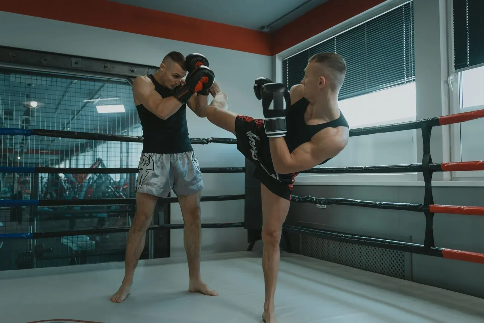 Muay thai fighter delivering a kick during sparring at a Koh Samui camp