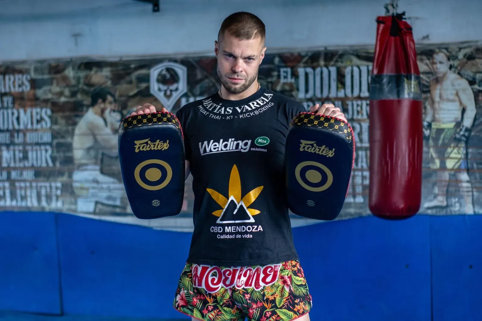 Muay thai fighter working the heavy bag during an evening session at a Koh Samui gym
