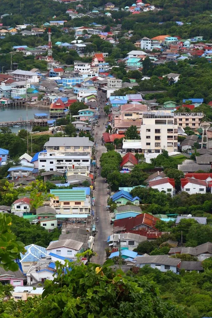 Aerial view of a coastal town with rooftops and greenery similar to Nathon's old town on Koh Samui
