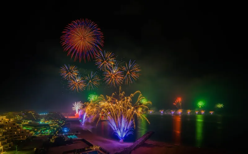 Fireworks display lighting up the coastline sky during a New Year celebration near Koh Samui