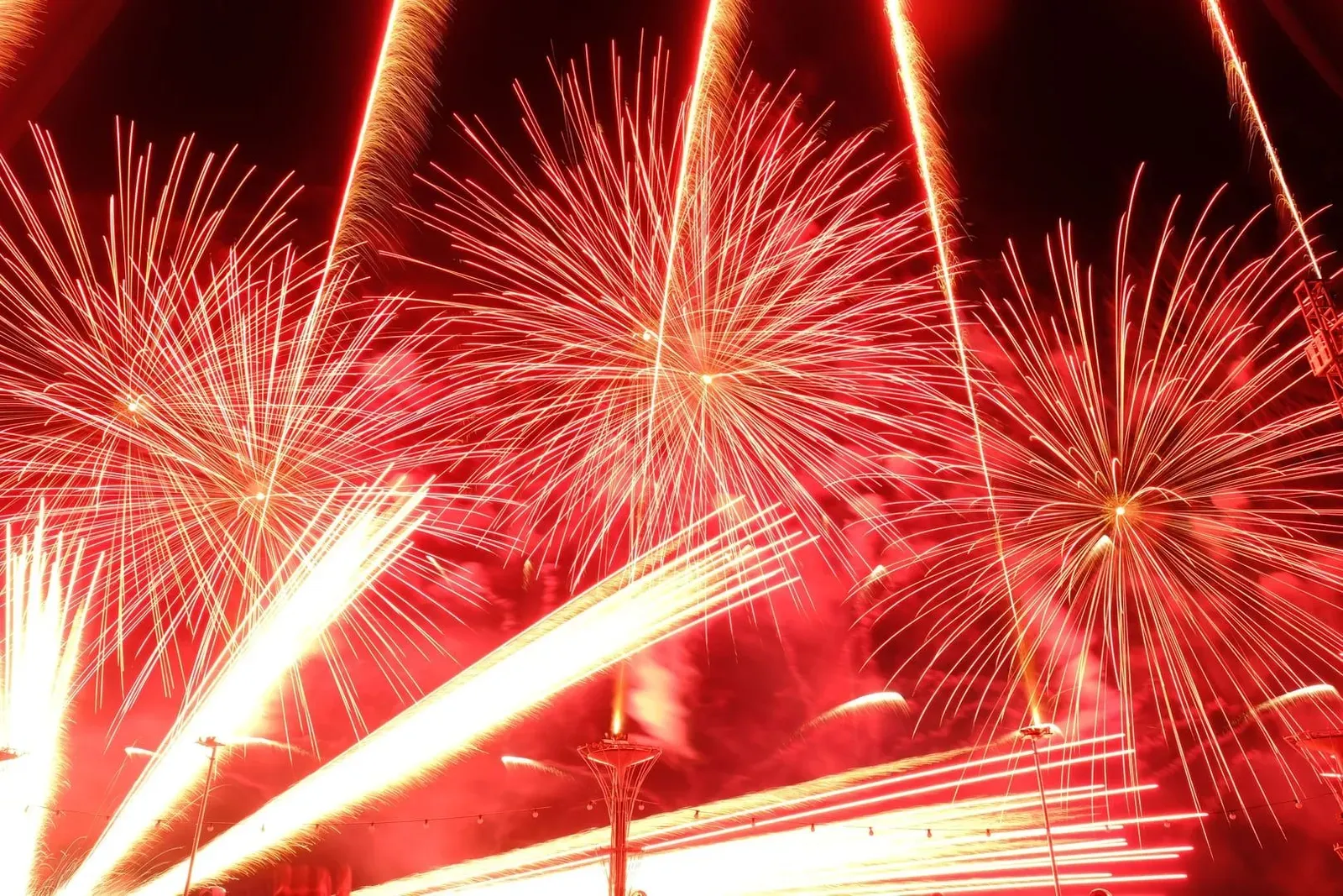Bright fireworks display illuminating the night sky above a quiet Koh Samui beach during New Year celebrations