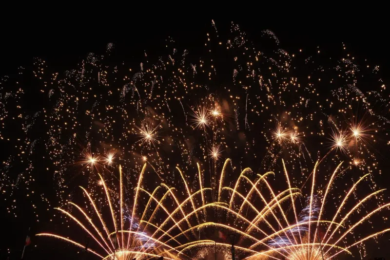 Bright multicolor fireworks display over the sky during a festive island New Year celebration