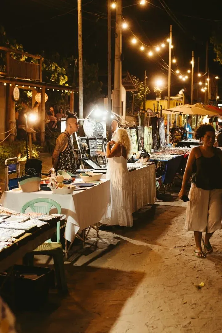 String lights and food stalls at a Koh Samui night market selling crafts and snacks