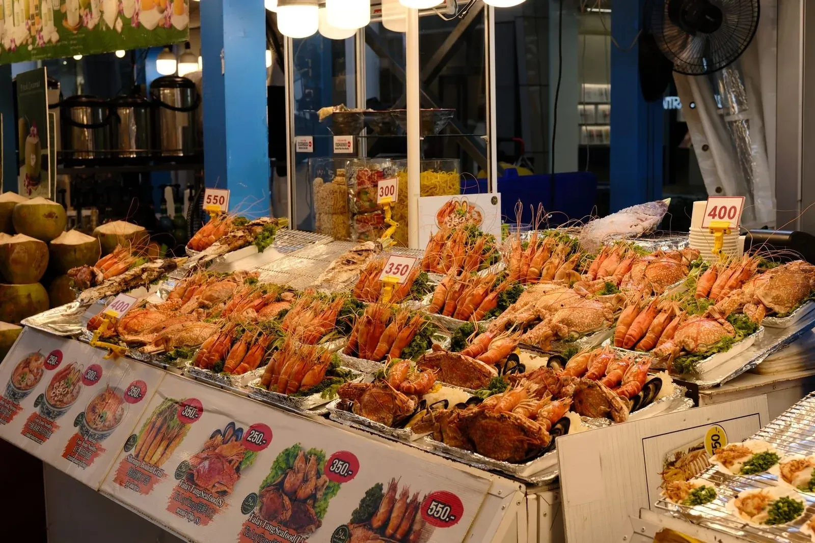 Fresh prawns and fish displayed on ice at a Koh Samui seafood market stall