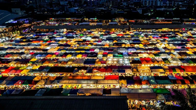 Aerial view of illuminated night market canopies and stalls in Koh Samui at dusk