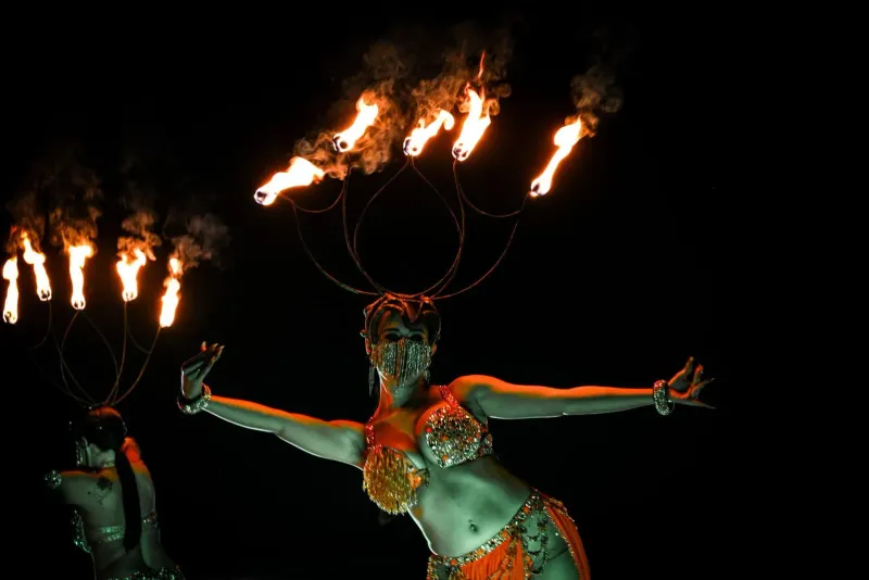 Fire dancers in costume performing at a Koh Samui night event