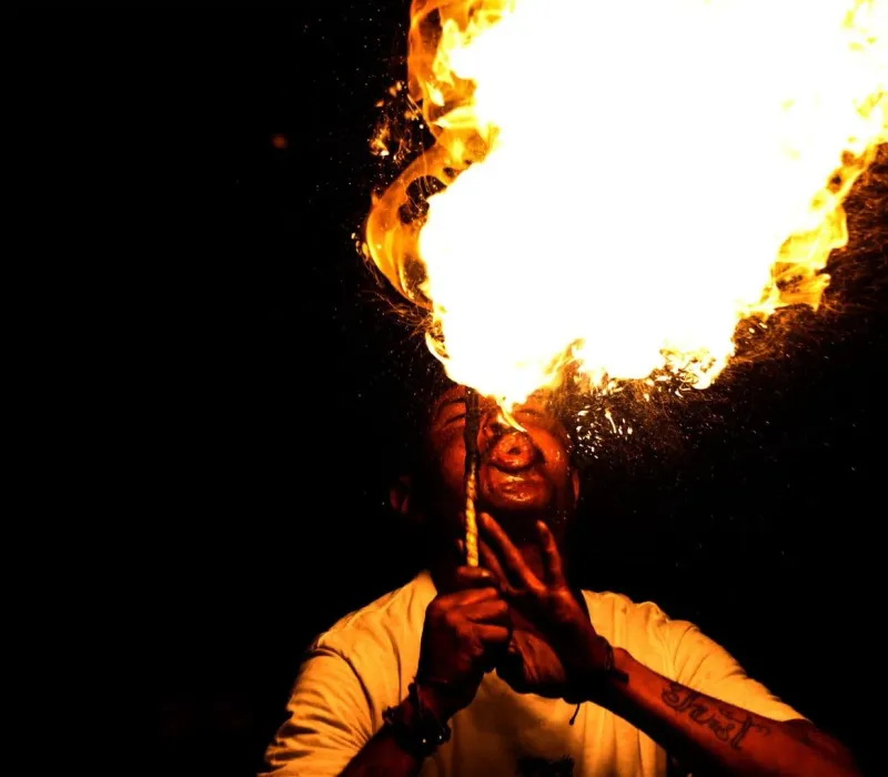 Fire breathing performer entertaining a crowd at a Koh Samui beach bar