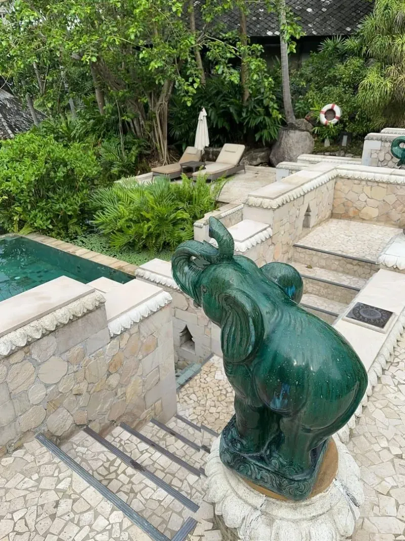 Tranquil private pool villa deck with lounge chairs in a lush Koh Samui-style garden