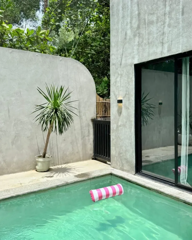 Poolside deck with sun lounger and tropical plant at a Koh Samui private villa rental