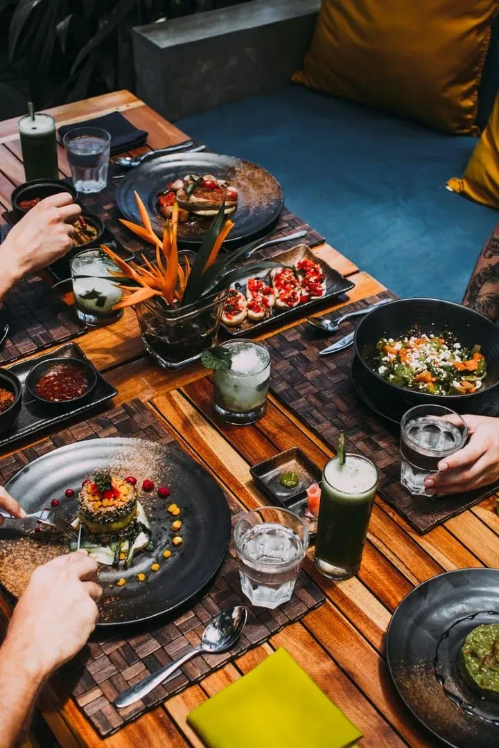Gourmet meal and drinks on a rustic table at a Koh Samui restaurant