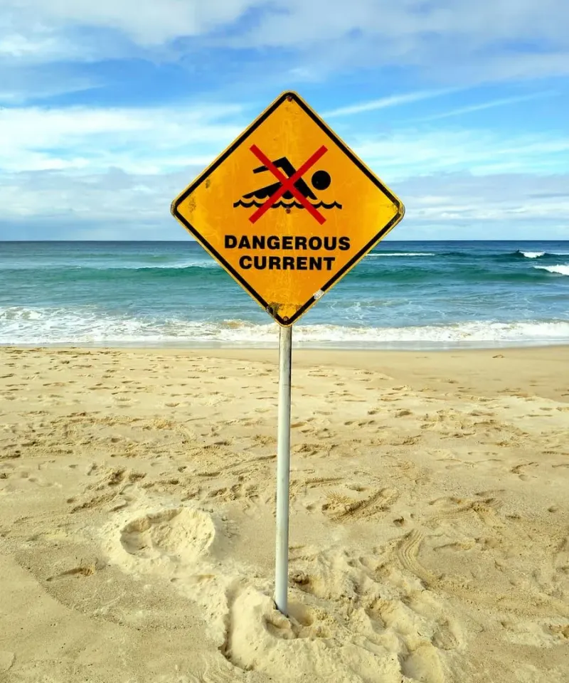 Dangerous current warning sign on a beach, similar hazards apply to Koh Samui's east coast