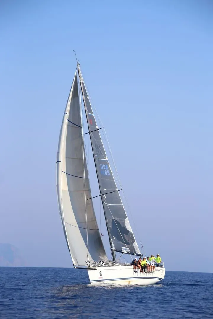 Guests sailing on a yacht under clear skies, similar to spectator sailing trips during Samui Regatta