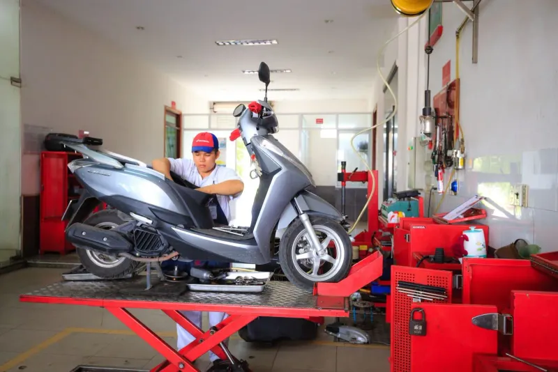 Small motorbike rental and repair shop typical of Koh Samui's roadside workshop scene