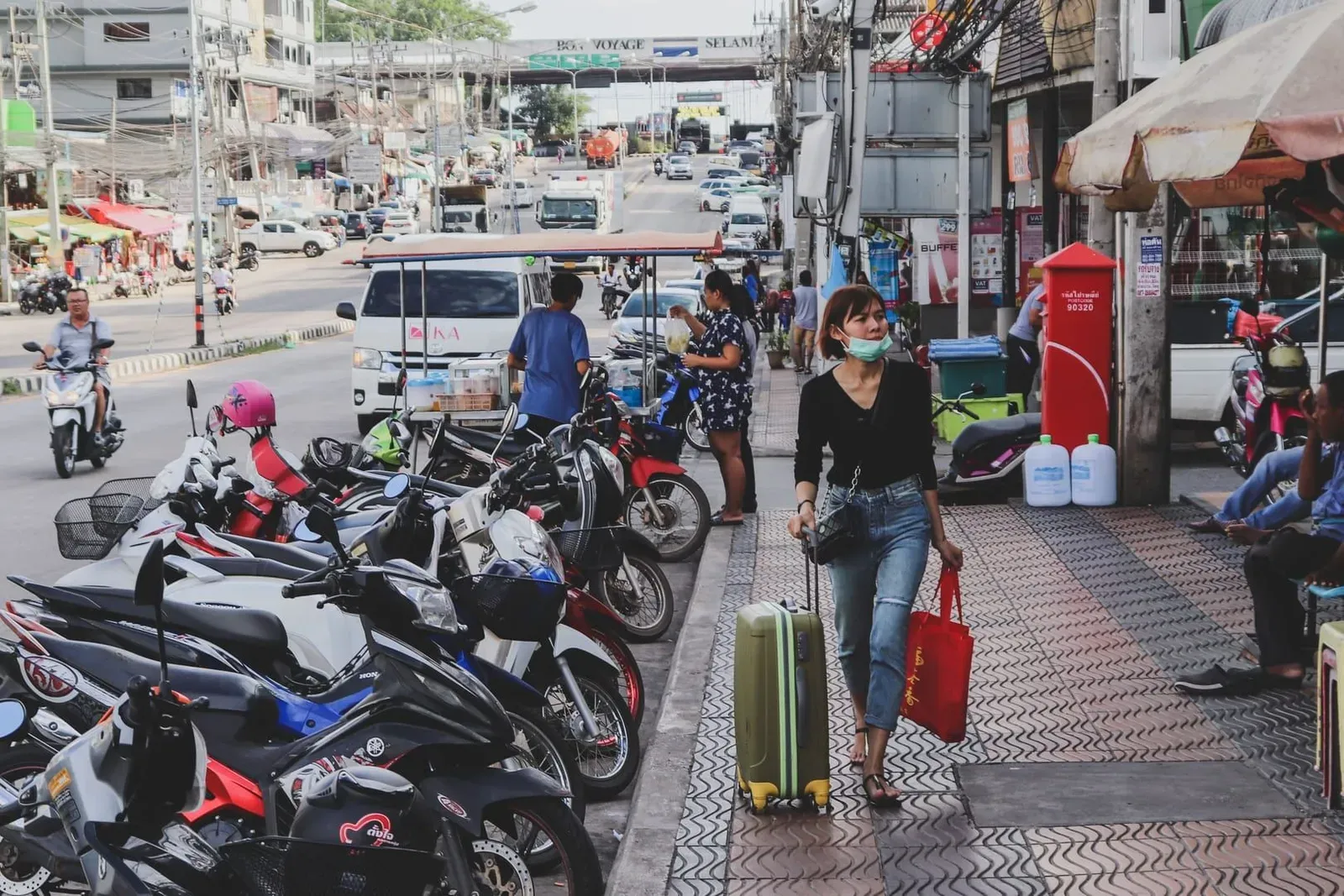 Row of scooters and motorbikes parked outside a small roadside shop on Koh Samui
