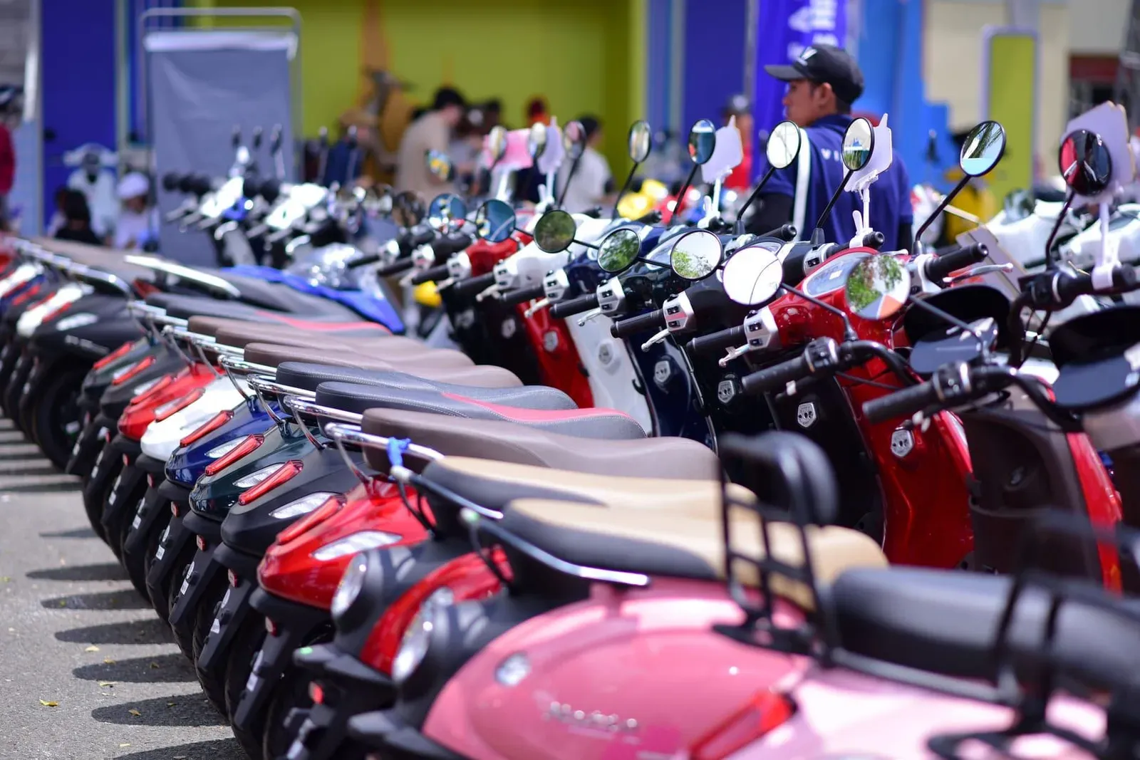 Vibrant row of scooters displayed outdoors at a Koh Samui rental shop