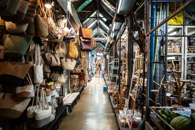 Aisle of souvenirs and goods at a bustling Thai weekend market similar to Koh Samui stalls