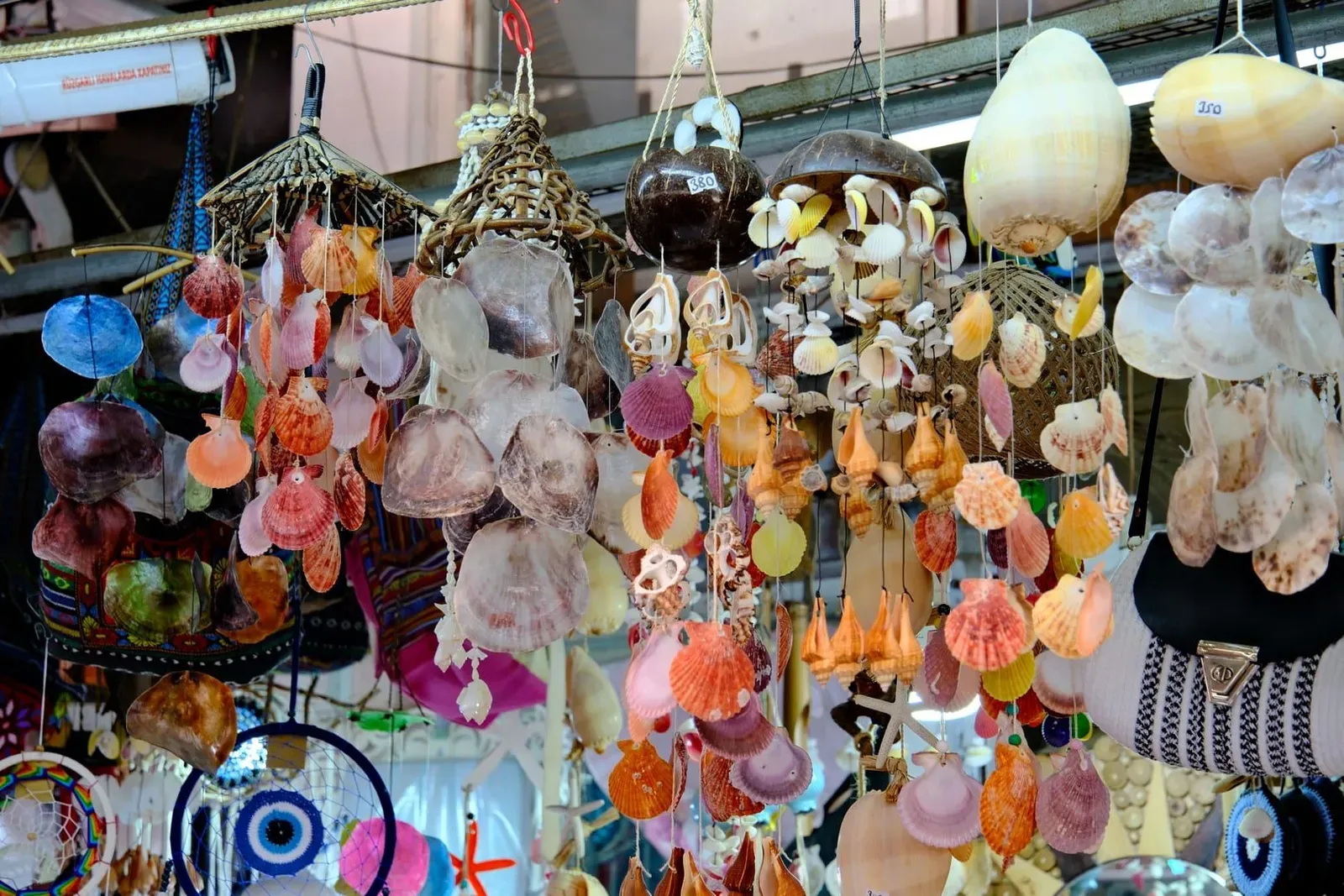 Handmade seashell and craft souvenirs displayed for sale at a Thai market stall