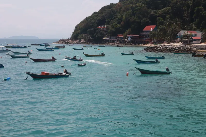 Small fishing boats on calm turquoise water near Koh Samui's quiet south coast