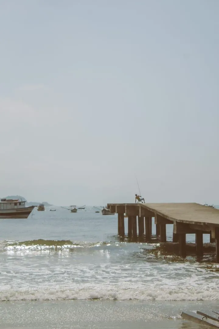 A fisherman at a quiet pier reflecting the working-village character of Bang Kao and Thong Krut